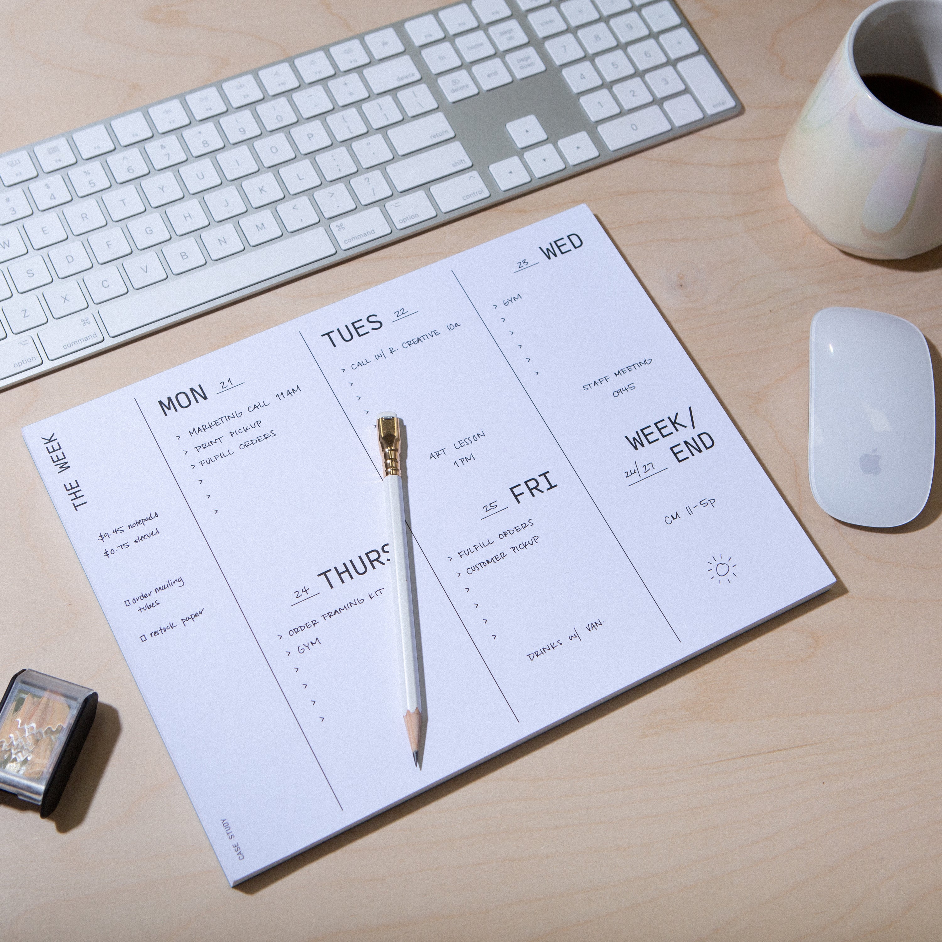 a weekly planner notepad sitting on a desk